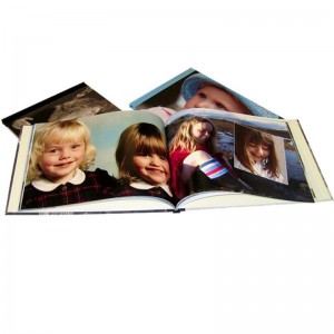 Ein aufgeschlagenes Fotobuch mit Fotos von zwei Mädchen.